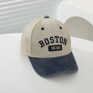 Detail of BOSTON 1630 embroidery on mesh trucker hat with blue denim brim