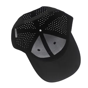 Detail view of laser-cut ventilation holes and adjustable strap on black baseball cap