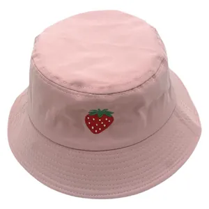 Cappello bucket in cotone rosa con ricamo a fragola dettagliato su sfondo bianco pulito