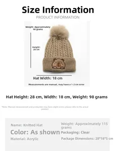 Close-up of kids' knit beanie featuring soft faux fur pompom and capybara embroidery