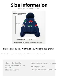 Detail view of jacquard car patterns and navy blue pom-pom on children's knitted hat