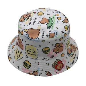 White reversible bucket hat featuring cute cartoon capybara prints and motivational quotes