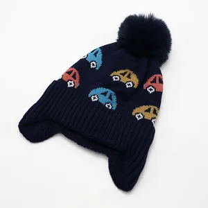 Close-up of knit texture and colorful car jacquard on children's navy winter beanie