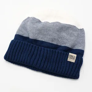 Detail view of the tri-color knit beanie with fleece lining and logo patch