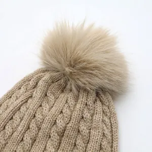 Detailed cable-knit texture and fluffy faux-fur pom-pom on the winter warm beanie hat