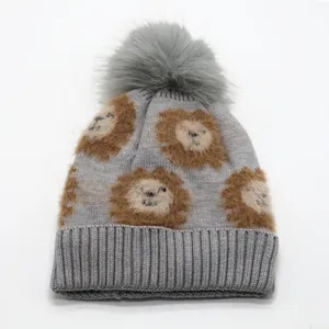 Grey knit children's lion hat with warm lining and soft faux fur pom-pom topper