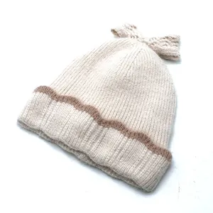 Détail de la maille côtelée avec nœud décoratif sur un bonnet d'hiver chaud