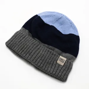 Close-up of tricolor ribbed knit beanie with soft fleece lining and branded patch