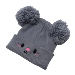 Cute kids knitted bear hat with pom-poms and embroidered animal face in dark grey