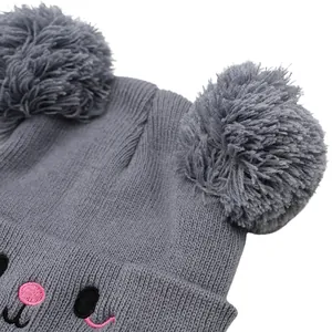 Cute grey knitted kids beanie with double faux fur pom poms and animal face embroidery