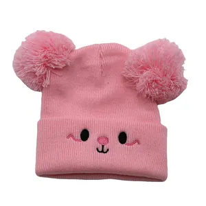 Cute pink knit children's beanie with double pom-poms and embroidered animal face