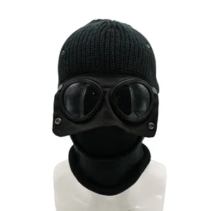 Detail of winter knitted hat with integrated pilot goggles and thermal neck gaiter set
