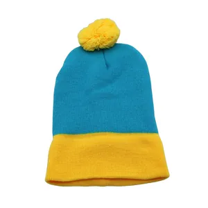 Detail of blue and yellow knit beanie showing fine texture and yellow pom-pom top