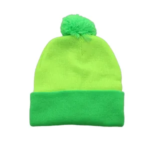 Two-tone neon green knit beanie with pom-pom detail for winter and holiday styling