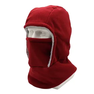 Macro detail of red thermal fleece balaclava with grey faux fur trim and windproof design