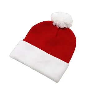 Detailed close-up of a festive red and white knit Christmas hat with a soft pompom