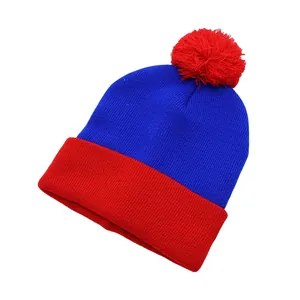 Detail of the blue and red knit texture and soft pom-pom on the winter beanie hat