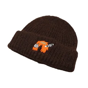 Close-up of thick coffee brown knit beanie featuring a cute cat embroidery with COOL text