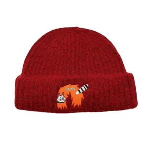 Detailed view of the dark red knit beanie featuring a cute embroidered cat and COOL text