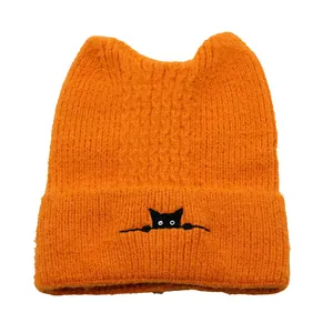 Vibrant orange knitted cat ear beanie with cute black kitten embroidery for winter warmth