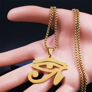 Close-up of golden Eye of Horus pendant on beaded chain held by a pink mannequin hand