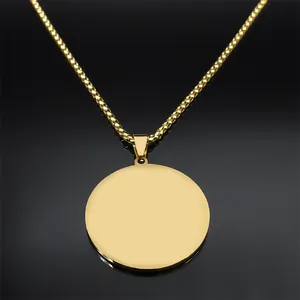 Macro detail of polished gold-plated stainless steel circular pendant and box chain