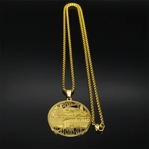 Detail of gold stainless steel Jerusalem skyline pendant necklace on reflective surface