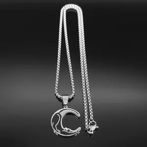 Macro shot of silver stainless steel wolf and crescent moon pendant with box chain link