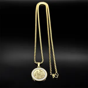 Macro shot of 18K gold plated circle pendant with Holy Family engraving and zircons