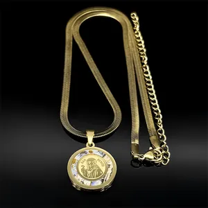 Detailed view of Saint Benedict pendant with shell inlay and golden herringbone chain