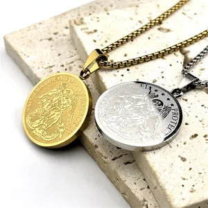 Macro view of gold and silver Saint Michael coin pendants on textured stone surface