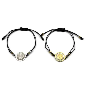 Gold and silver San Benito cross woven bracelets with mother of pearl inlay on white background