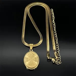 Detail of gold-plated Saint Christopher pendant with elegant flat snake chain on black background