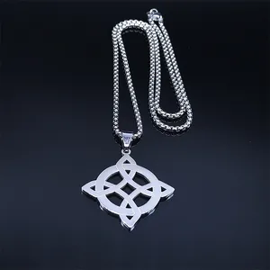 Macro shot of polished stainless steel Celtic knot pendant necklace on a reflective surface