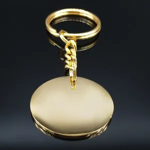 Polished gold stainless steel teacher keychain with circular pendant on black background