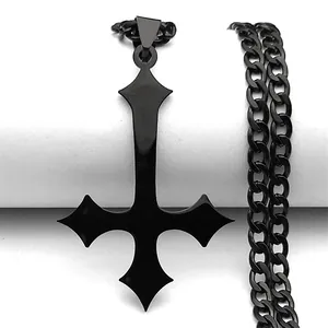 Macro shot of a black gothic inverted cross pendant with a thick metal curb chain
