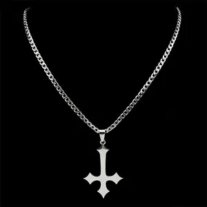 Polished silver inverted cross pendant with cuban chain necklace on black background