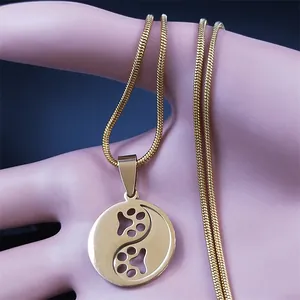 Golden stainless steel Tai Chi pendant necklace with hollow pet paw print design