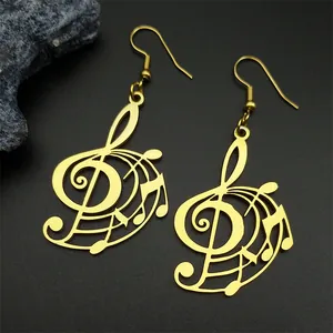 Macro detail of gold treble clef musical note earrings on black textured surface
