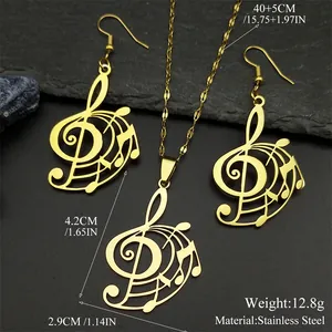 Gold stainless steel musical note necklace and earrings set on dark stone background