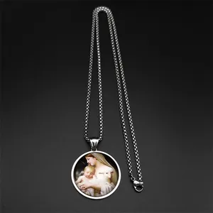 Detailed macro view of vintage religious painting on silver box chain pendant necklace