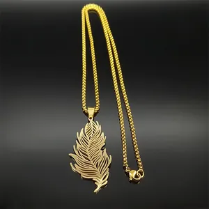 Close-up of golden stainless steel hollow feather pendant and chain with reflection