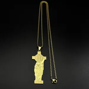 Close-up of golden Saint Benedict cross necklace with detailed religious engraving