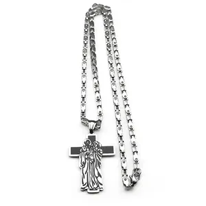 Detailed close-up of a stainless steel cross necklace with a holy family religious engraving