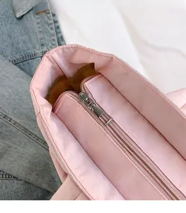 Close-up of pink quilted tote bag showing high-quality metal zipper and smooth opening