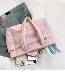 Pink quilted puffer tote bag interior showing large capacity with personal essentials