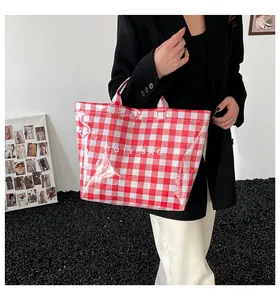 Close-up of red and white checkered tote bag with clear PVC finish and Tote Bag text