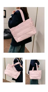 Detail of pink quilted tote bag with padded straps showing spacious side pocket design