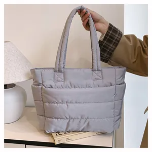 Close-up of light purple quilted puffer tote bag with side pocket and padded handles