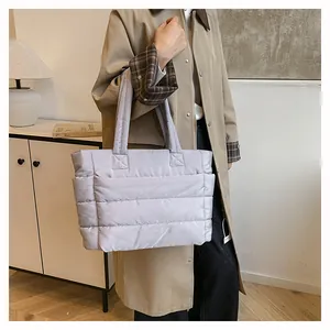 Close-up of quilted lavender tote bag with soft down-like padding and wide shoulder strap